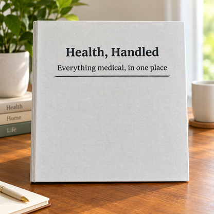 Health, Handled medical organizer binder with a white cover reading “Everything medical, in one place,” standing on a wooden table.