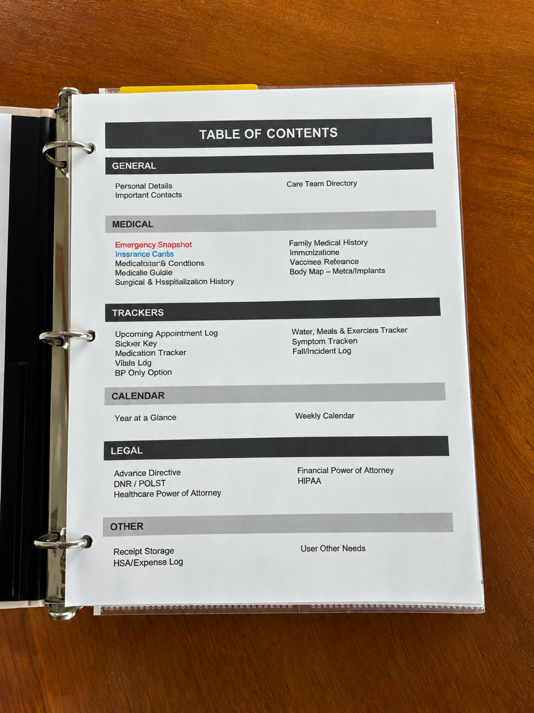 Health, Handled medical organizer open to its table of contents, listing general information, medical records, trackers, calendar, legal documents, and other sections.